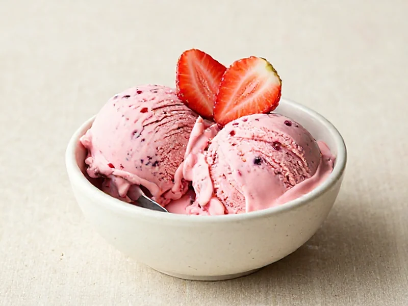 Strawberry protein ice cream served in a cream bowl